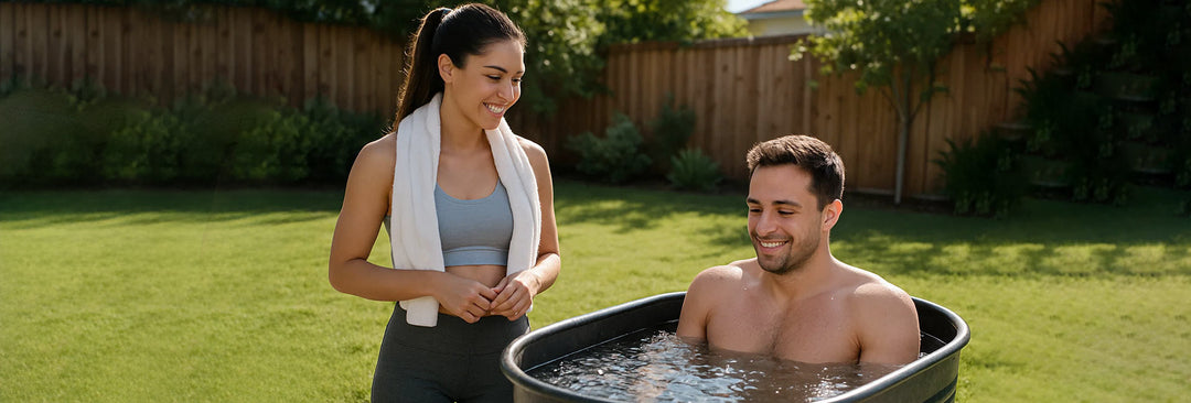 Smiling couple enjoying safe ice bath experience with woman providing support during outdoor cold plunge therapy session.