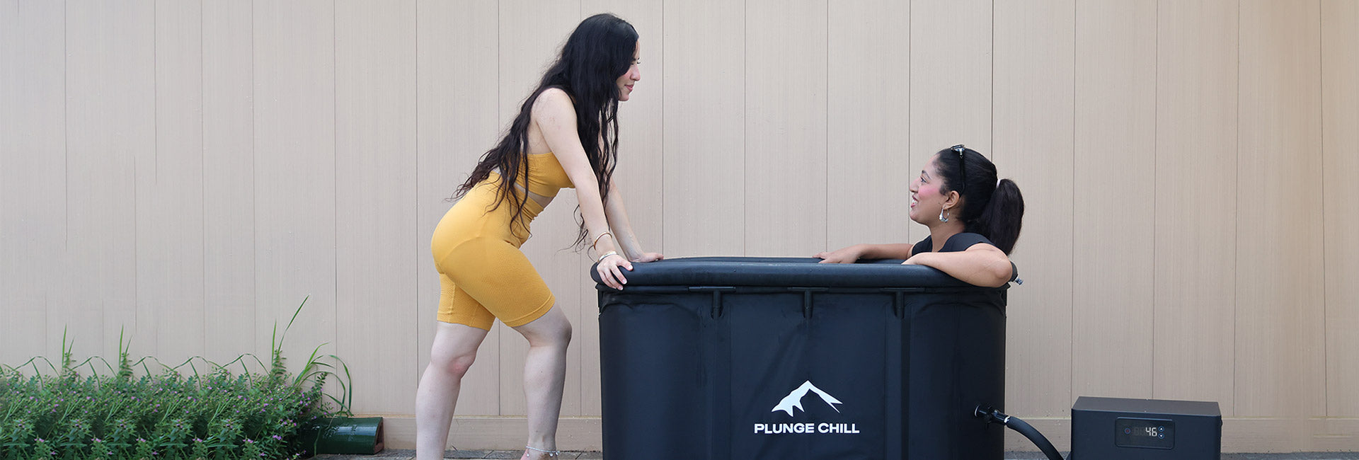 Two women using Plunge Chill cold plunge tub for ice bath weight loss therapy and brown fat activation.