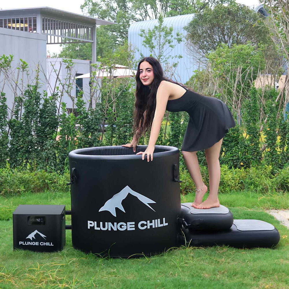 Woman relaxing in a Plunge Chill PVC cold plunge tub on a sunny deck, perfect for home cold therapy