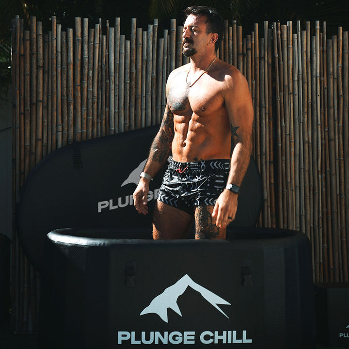A man stand in a plunge chill pro and take a deep breath. 