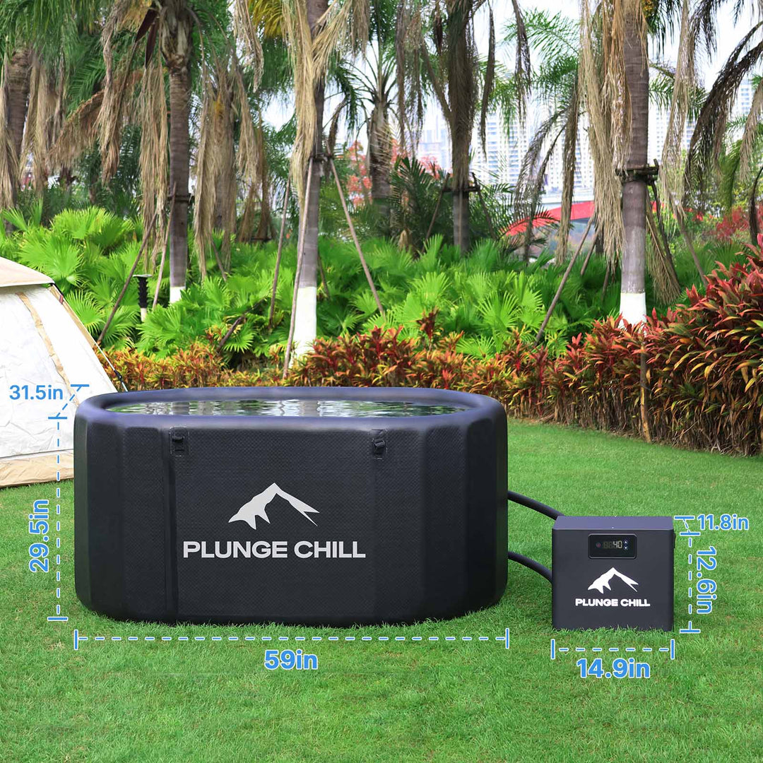 An oval black inflatable cold plunge tub and a chiller with blue dimension labels on a green lawn.