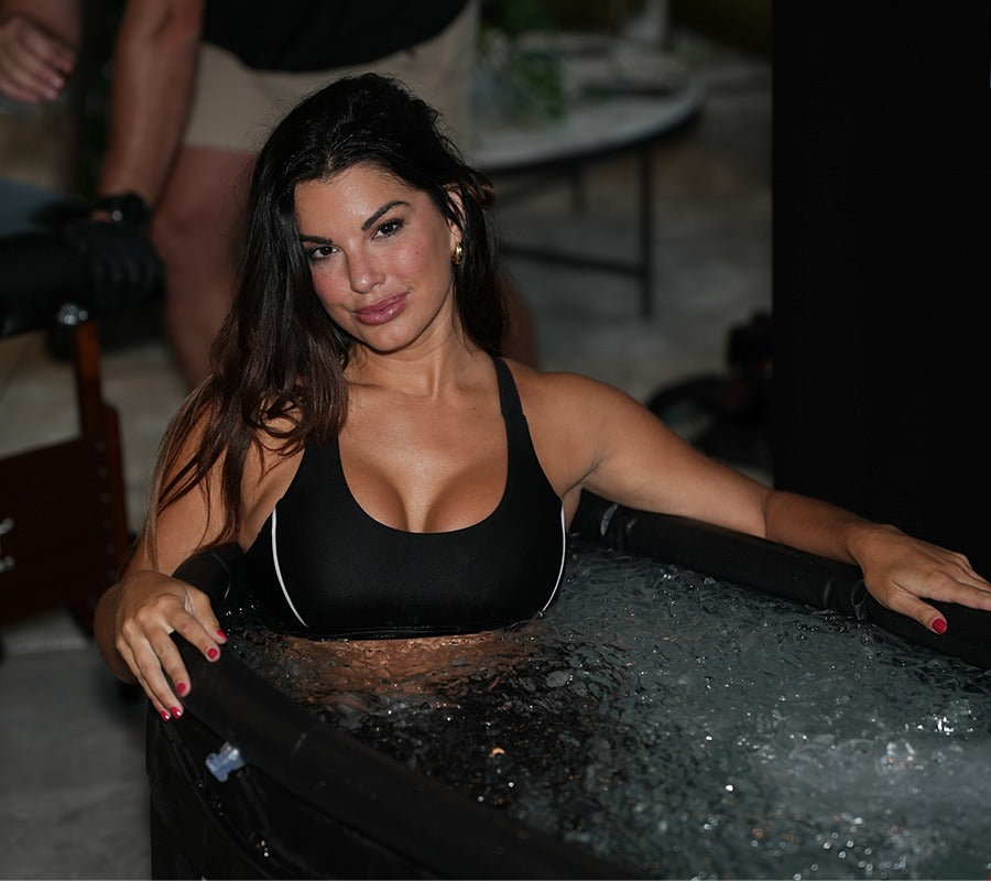 Cold Plunge-A fit woman takes a cold bath in a cold plunge tub.